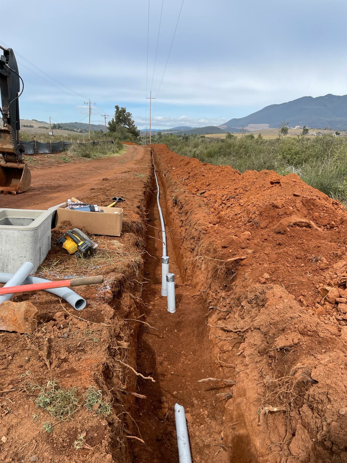 Open utility trench with underground piping